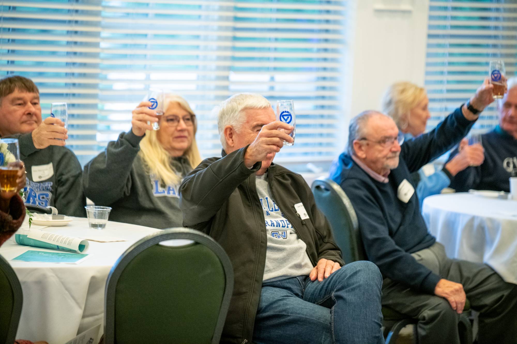 Alumni raising a toast at breakfast.